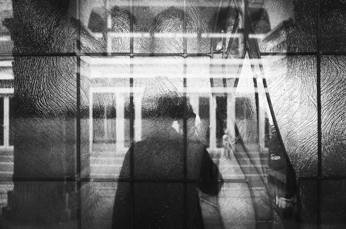 silhoutte of woman on window glass panes